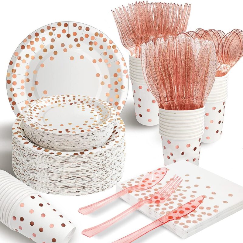 A complete set of AIRE rose gold polka dot disposable dinnerware, including plates, cups, napkins, and cutlery, arranged eleg