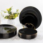 A complete Bestluck 350-piece black and gold disposable dinnerware set arranged for 50 guests, featuring plates, cups, and cu