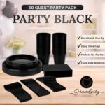 Complete black disposable dinnerware set with plates, cups, napkins, forks, knives, and spoons neatly arranged.