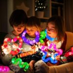 A set of 12 glowing light-up wands in various colors including green, red, blue, pink, orange, and purple.
