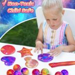 A set of 24 small, multi-colored galaxy slime jars with shimmering textures, packaged together for party favors.