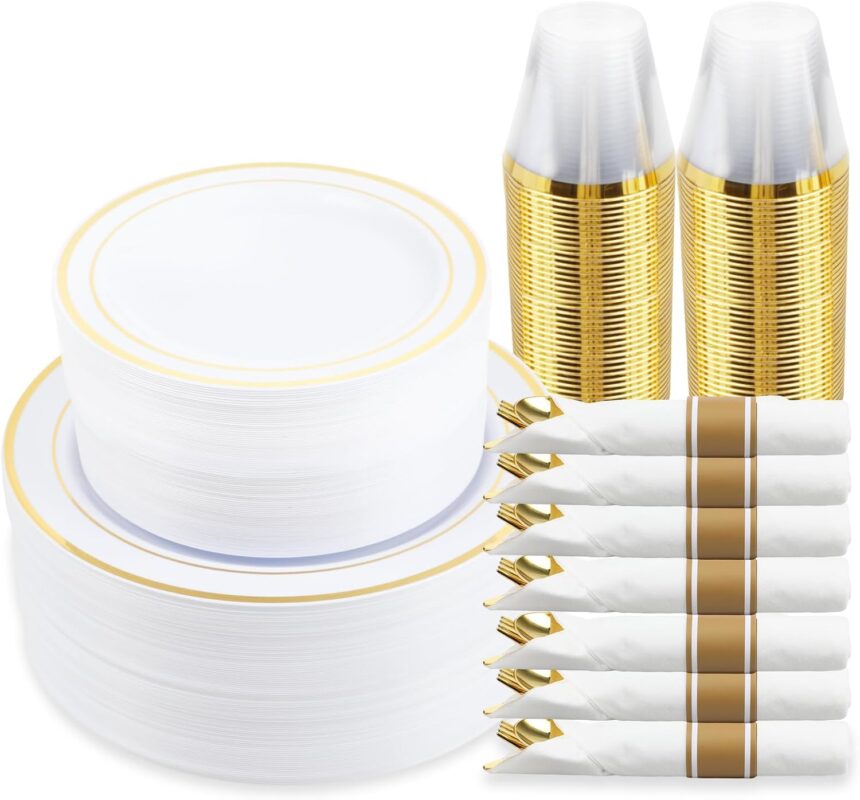 A full place setting of M MCIRCO gold-rimmed plastic dinner plates, salad plates, gold plastic silverware, and a clear gold-r