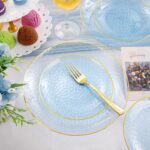 Rubtlamp 175-piece blue plastic dinnerware set with gold rim, including plates, cups, cutlery, and napkins for a party.